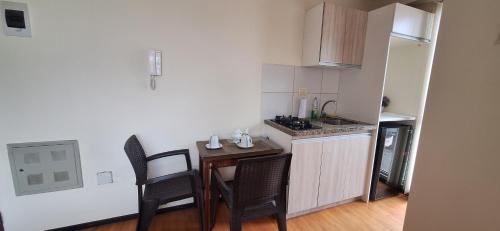 a small kitchen with a table and chairs in a room at Mini Loft Deluxe in Cochabamba