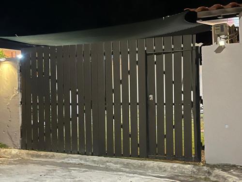 a black gate on a house at night at La casita de alado in Aguacatal