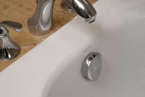 a white sink with a silver faucet on a counter at Eaton Hotel Dalian Airpot & HSR Station in Jinzhou