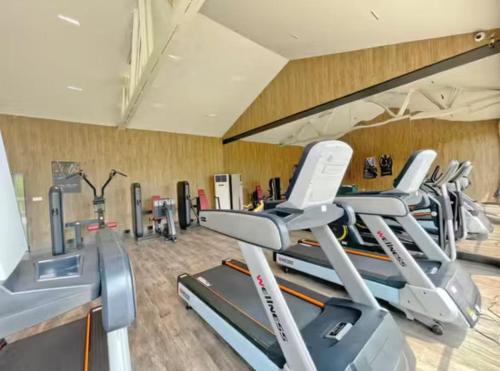 a gym with several tread machines in a room at Lin Yin Art Hotel Shanghai（Pudong airport） in Shanghai