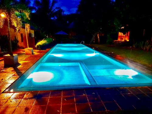 a swimming pool in a backyard at night at Eliyanth Udawalawe in Udawalawe