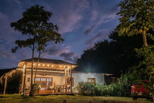 a house with a lit up facade at night at Villa Patricia - Tres Unidos in Tres Unidos