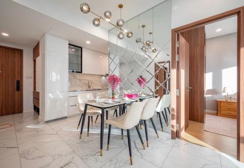 a dining room with a table and chairs at THE METROPOLE Apartment Complex OPERA-GALLERIA-CREST in Ho Chi Minh City