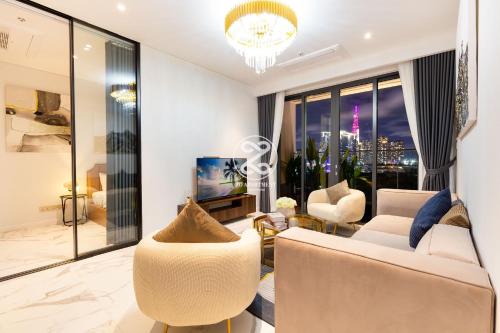 a living room with white furniture and a large window at THE METROPOLE Apartment Complex OPERA-GALLERIA-CREST in Ho Chi Minh City