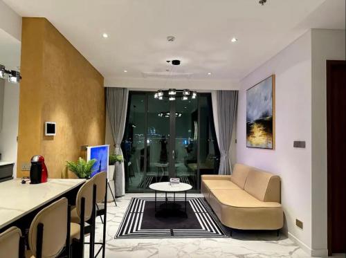 a living room with a couch and a table at THE METROPOLE Apartment Complex OPERA-GALLERIA-CREST in Ho Chi Minh City
