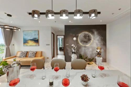 a living room with a table with glasses of wine at THE METROPOLE Apartment Complex OPERA-GALLERIA-CREST in Ho Chi Minh City