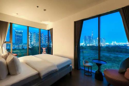 a bedroom with a large bed and a large window at THE METROPOLE Apartment Complex OPERA-GALLERIA-CREST in Ho Chi Minh City