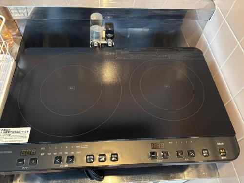 a close up of a laptop screen on a stove at Orange Stay Matsuyama in Matsuyama
