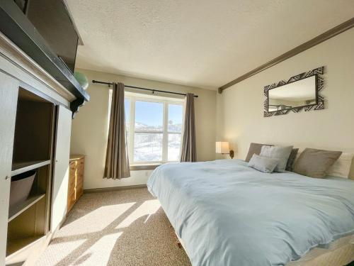 a bedroom with a large bed and a large window at 7 Guests 2BR 2BA Pool Hot Tub & Game Room at CBL in Brian Head