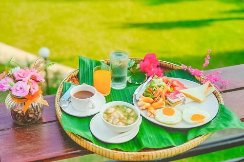 a tray of breakfast food on a picnic table at Saitharn Iyara Resort in Sai Yok