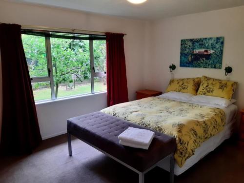 a bedroom with a bed and a window at Sunny Family Haven with Pool in Napier