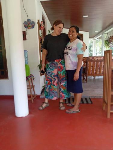 two women standing next to each other in a room at Sigiriya Moonlight Home in Sigiriya