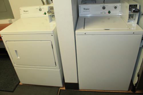 a white refrigerator next to a white washer and dryer at Eco-Lux Inn Norfolk in Norfolk