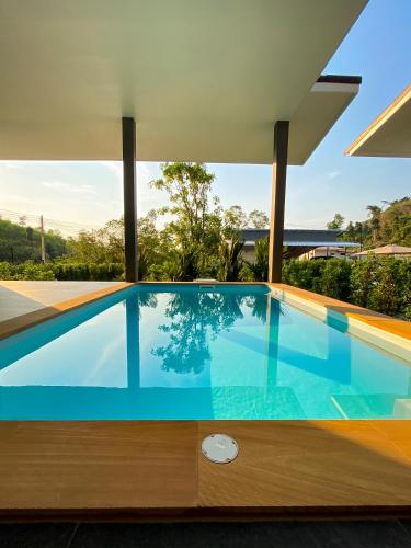 a swimming pool in the middle of a house at Hornbill Pool Villas 1 in Ko Chang