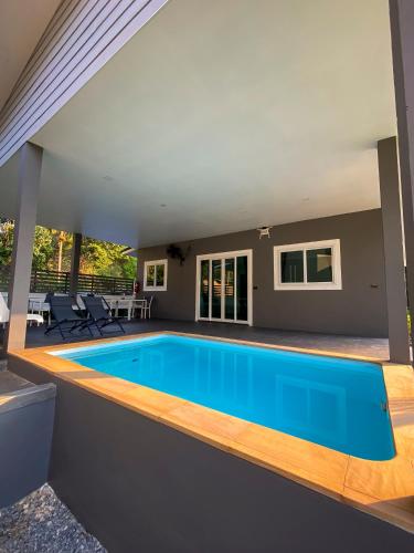 a swimming pool in the middle of a house at Hornbill Pool Villas 1 in Ko Chang