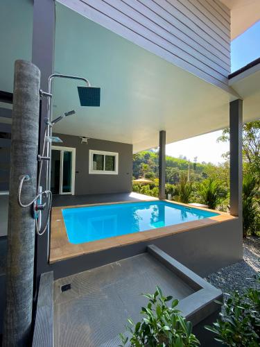 a swimming pool in the backyard of a house at Hornbill Pool Villas 1 in Ko Chang