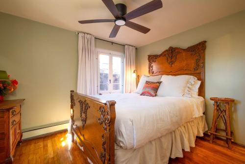a bedroom with a bed with a ceiling fan at Casita Gomez- Courtyard - Quiet - Railyard - 1BR in Santa Fe