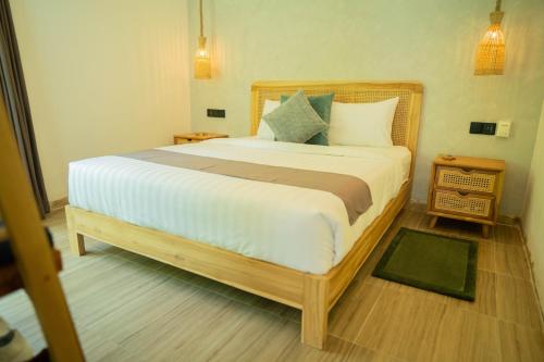 a bedroom with a large bed in a room at Nomada Villas in Kuta Lombok