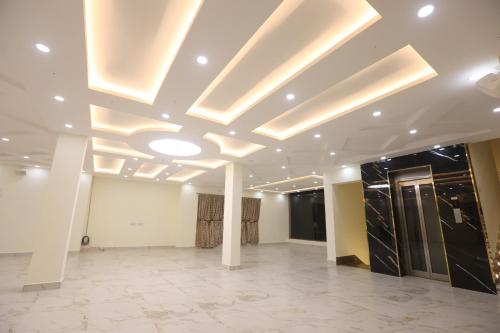 a large room with a ceiling with lights at MM Beach House & Party Hall in Chennai