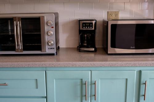 a kitchen counter with a microwave and a coffee maker at Villa jaden #2 in Road Town