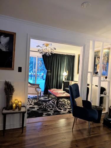 a living room with a couch and a chair at La Tremblante in Mont-Tremblant