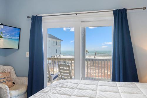 a bedroom with a bed and a view of the ocean at Cape Ocean Front - Jacuzzi - Elevator - Arcade Games! in Port Saint Joe