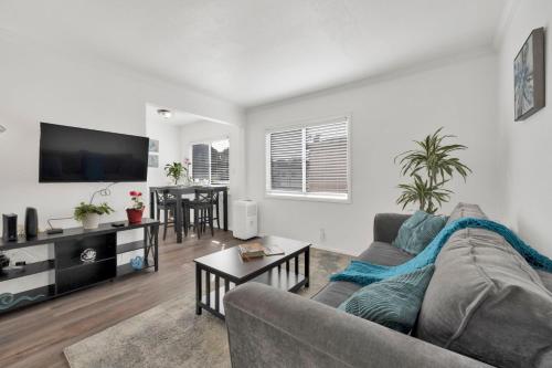 a living room with a couch and a table at Cozy, Luxurious, Oasis, With Free parking in Los Angeles
