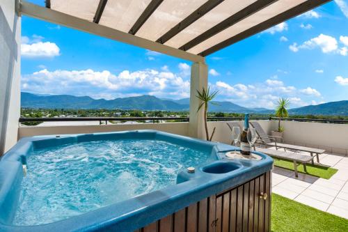 a hot tub on the balcony of a house at Cairns Penthouse - Private Rooftop Outdoor Gym, Spa & TV Area with Sunset & Mountain Views in Cairns