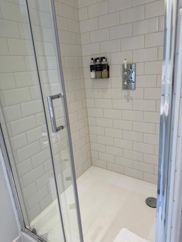 a shower stall with a glass shower door at Wellwood Manor in Pitlochry