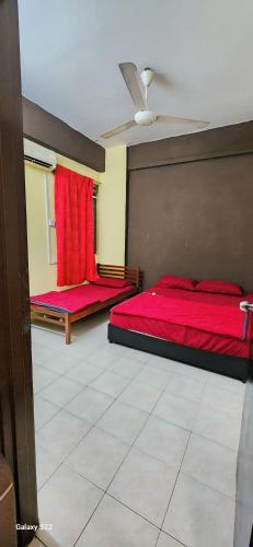 a bedroom with two beds with red sheets and a ceiling at Homestay Nilai, Airport KLIA and KLIA2 in Nilai