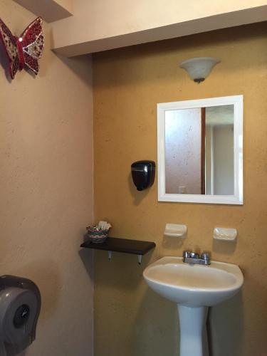 a bathroom with a sink and a mirror at Hotel Real Santa María in Cuernavaca