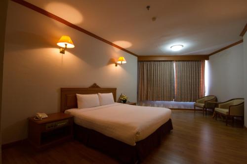 Un pat sau paturi într-o cameră la Rimpao Hotel