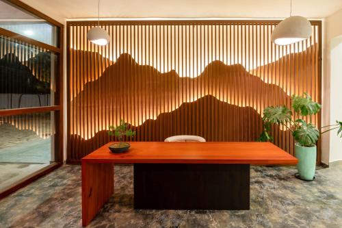 a wooden desk in a room with mountains on the wall at Arambhaya Boutique Hotel in Kandy