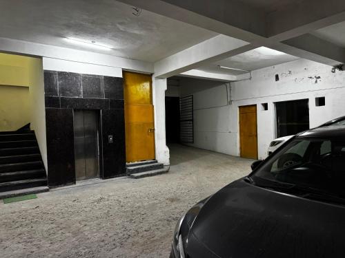 an empty room with a car parked in it at #The Vaikunth# Mcleodganj# Dhauladhaar View# Big free Parking# Ac rooms Centrally#Elevator#Soundproof rooms# in Dharmsala