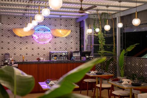 a restaurant with tables and a bar with lights at Arambhaya Boutique Hotel in Kandy