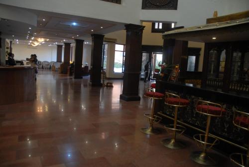 a lobby with a bar and stools in a building at Hotel Vaishali in Kathmandu