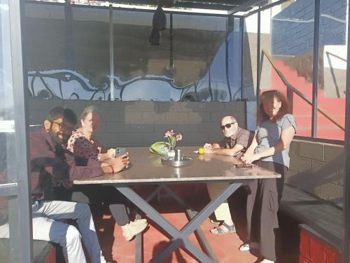 a group of people sitting at a table at Longwood Resorts in Kotagiri