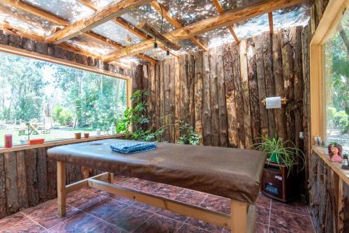 a room with a bench in front of a wooden wall at Bosques del Paico in El Monte