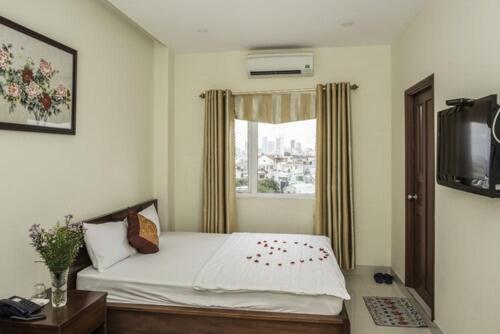 a bedroom with a bed and a window at Smile hotel in Da Nang