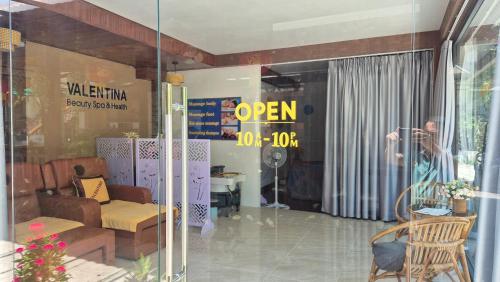 a woman taking a picture in a store window at Valentina Resort & Spa Phu Quoc in Phu Quoc