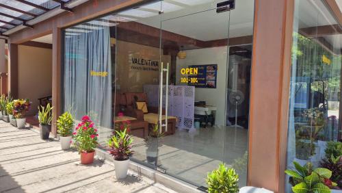 a store front with potted plants on a porch at Valentina Resort & Spa Phu Quoc in Phu Quoc