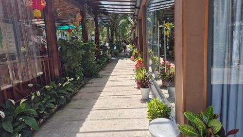 a sidewalk with potted plants in a building at Valentina Resort & Spa Phu Quoc in Phu Quoc