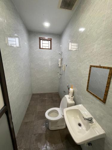 a bathroom with a white toilet and a sink at 2 JB Adda Daya Setia Eco Austin 24paxs Pool Table Karaoke BBQ Corner Unit in Johor Bahru