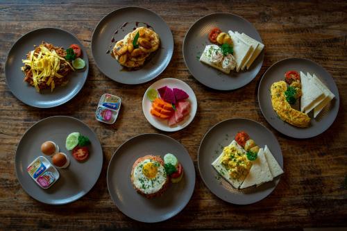 a group of plates of food on a wooden table at Abhirama Villas and Spa in Ubud