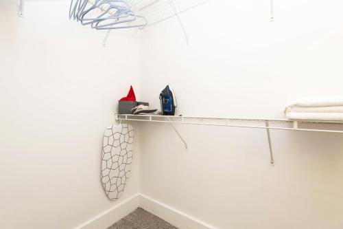 a room with a white wall with a shelf at Sky-Rise Apartments in Los Angeles