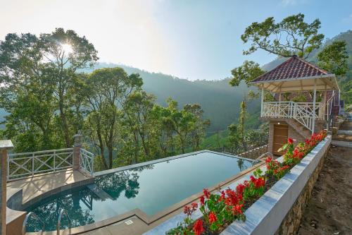 a swimming pool with a gazebo and flowers at The Planet Munnar in Suryanelli