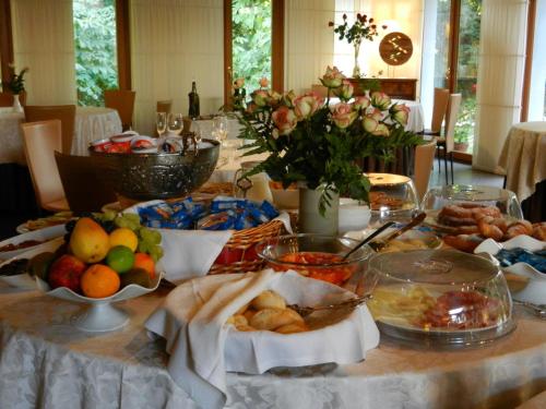 a table with a bunch of food on it at Eurohotel Palace Maniago in Maniago