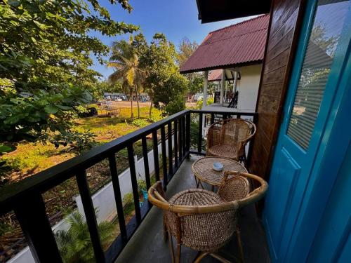 a balcony with a table and chairs on it at Mahaon surf hotel in Weligama