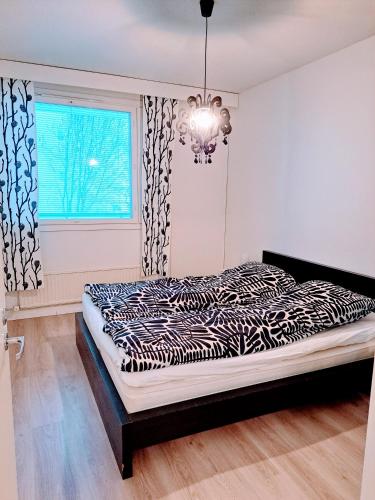 a bedroom with a zebra print bed in front of a window at Spacious Northern City Apartment in Rovaniemi