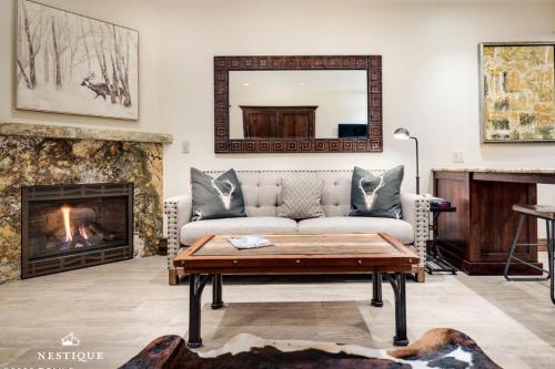 a living room with a couch and a fireplace at LMV A-107 in Park City